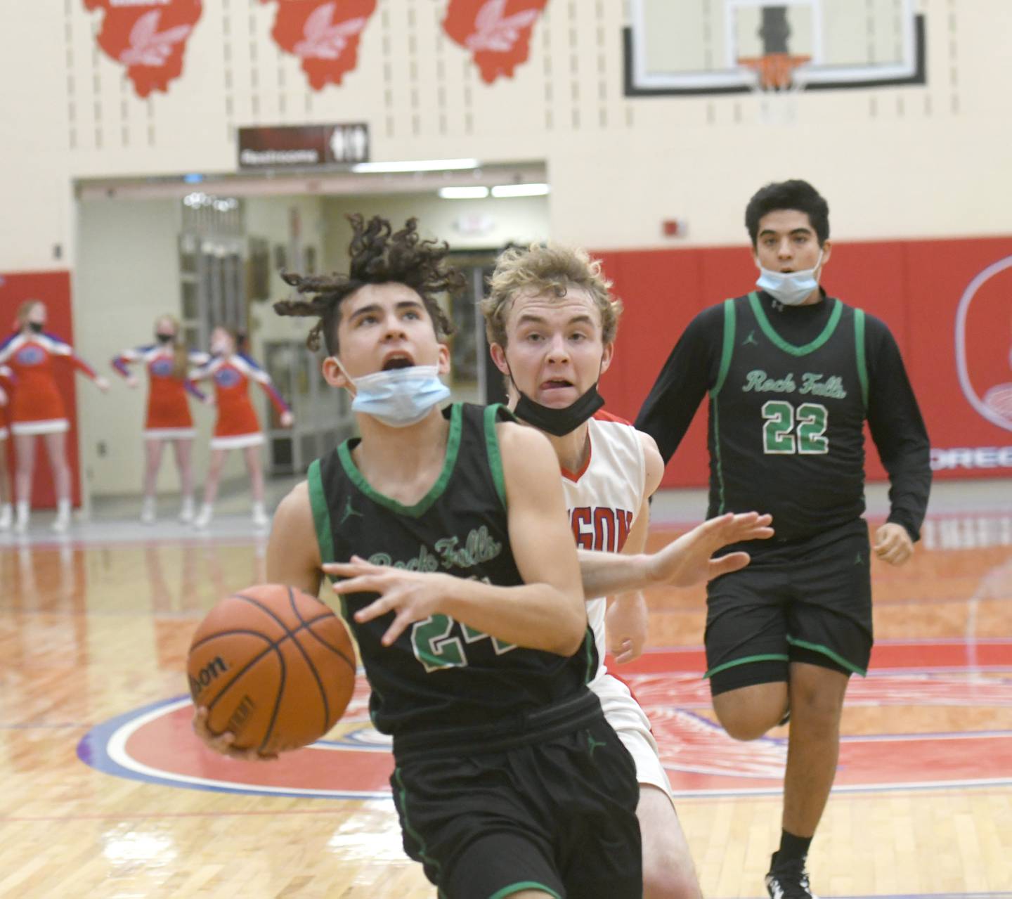 Rock Falls' Austin Castaneda drives to the basket as Oregon's Issac Reber tries to catch him during Friday action at the Blackhawk Center in Oregon.