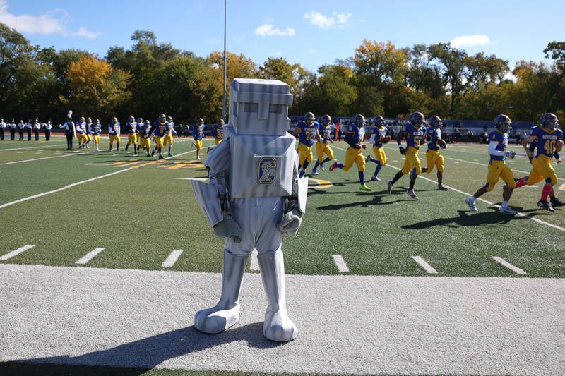 Joliet Central’s mascot the Steelman stands on the sidelines as Joliet Central enters the field before the game  against Joliet West on Saturday.