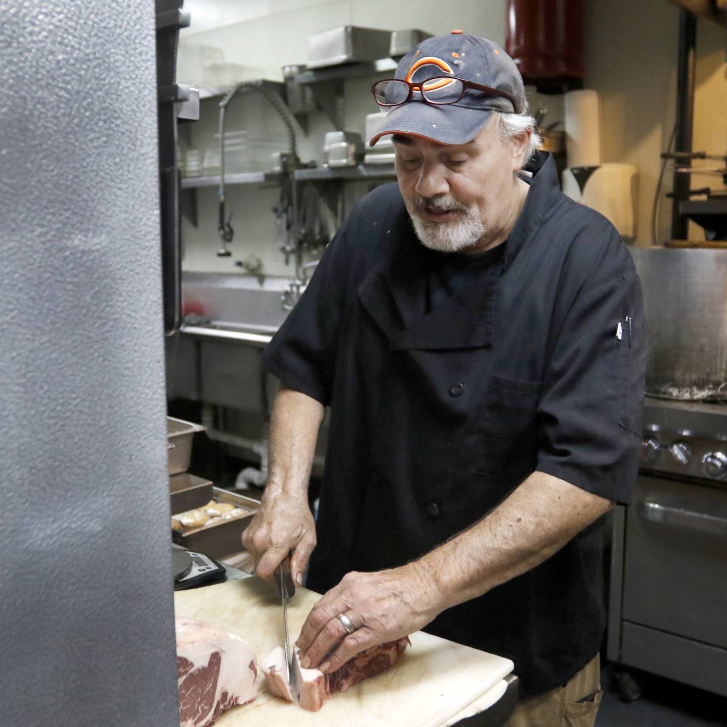 Michael Borlek, the executive chef at the Addison's Steakhouse, cuts steaks as he prepares food for the dinner service Thursday, Sept. 7, 2022, at the restaurant, 335 Front St. in McHenry. Some area restaurants are still struggling to find staff.