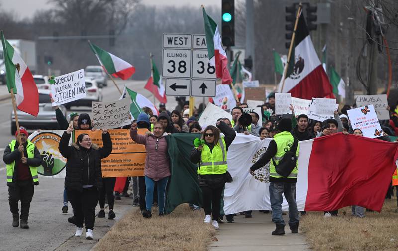 Protestors demonstrated against U.S. Immigration and Customs Enforcement raids Monday along Route 59  in West Chicago, saying President Trump’s mass deportation plan unfairly targets Latino residents.