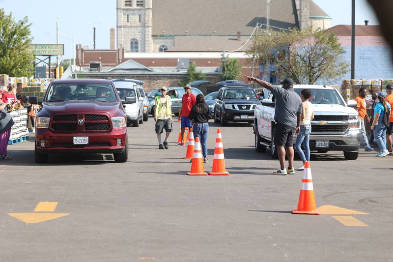 Cars line up outside the Will County Office Building for the Free Food Giveaway on Saturday, July 27, 2024 in Joliet. Will County and the city of Joliet partnered with ShareFest Will County to give out food and gift cards to help with recovery from last week’s severe storms.