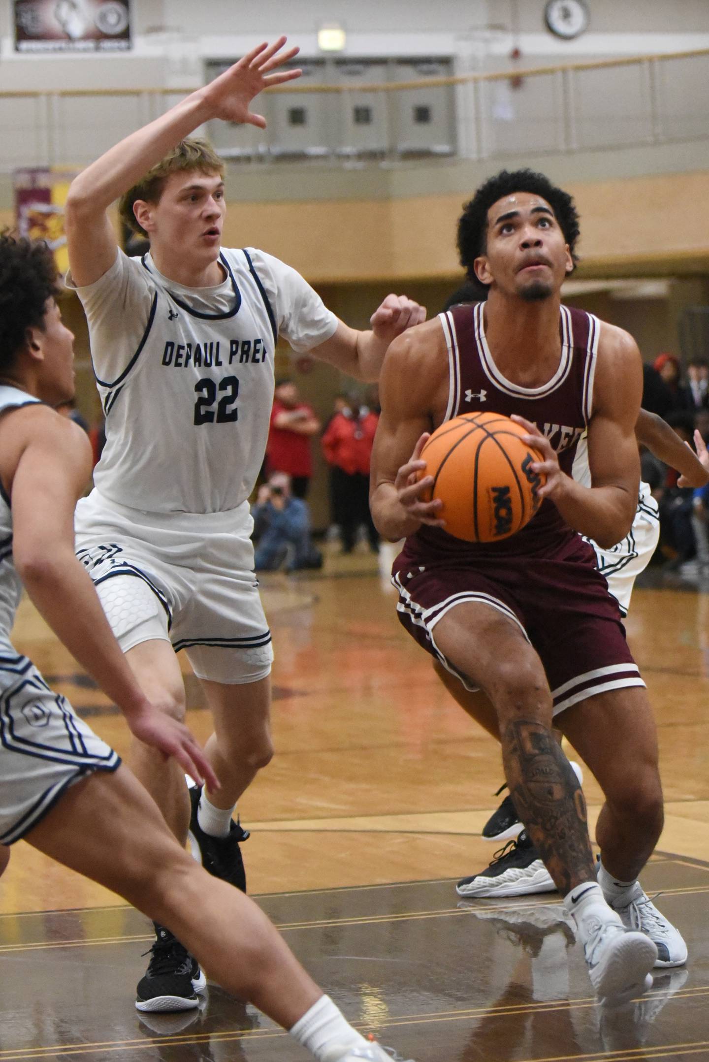 Kankakee's EJ Hazelett, right, drives past DePaul Prep's Gus Johnson on his way to the basket during a game at the Team Rose Shootout at Mount Carmel Sunday, Dec. 14, 2025.