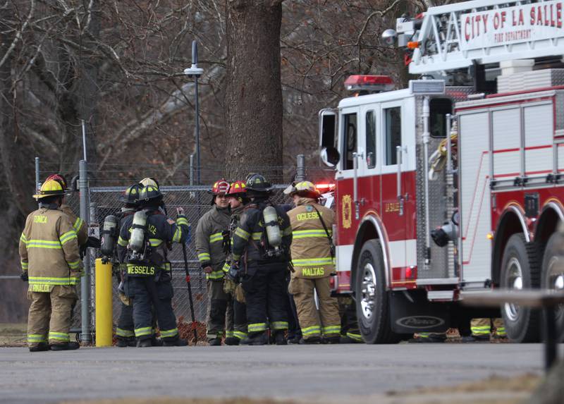 Firefighters gather at the entrance of the Starved Rock Lock and Dam on Tuesday, Jan. 13, 2026 near Utica. A light haze of smoke was coming from inside the Peru Hydroelectric Power Plant.  Fire departments from Tonica, La Salle, Wallace, Tonica, Peru and Utica all responded to the scene. The incident happened shortly before 2:30p.m. No injuries were reported.