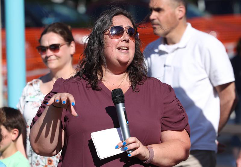 Chrissy Tluczek, superintendent of recreation with the DeKalb Park District, makes some remarks before the ribbon cutting Friday, June 14, 2024, at the new playground at Hopkins Park. The park district was hosting a Dedication Celebration event at the park for the grand opening of the new playground and racquet courts.
