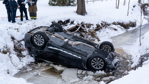 Person hospitalized with possible hypothermia after rollover crash into water near Elgin