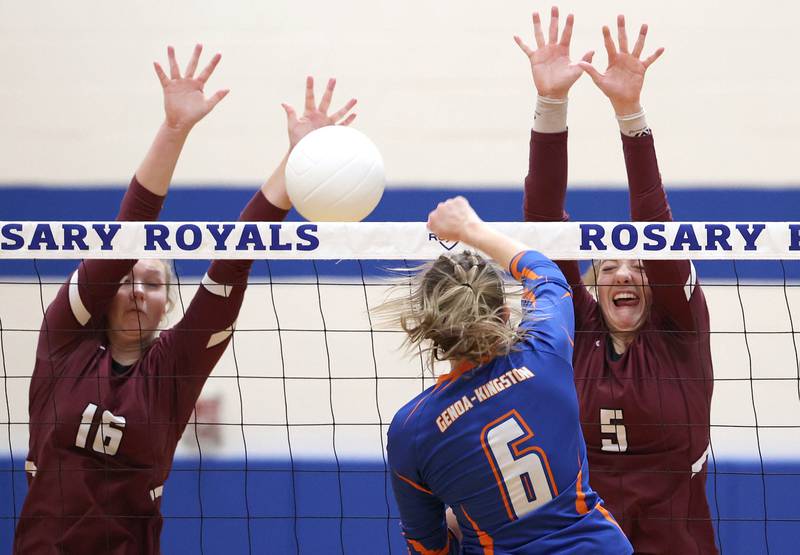 Marengo's Mia Lulinski (left) and Marengo's Gianna Almeida try to block the spike of Genoa-Kingston's Kaitlin Rahn Thursday, Oct. 27, 2022, during their Class 2A Regional final match at Rosary High School in Aurora.