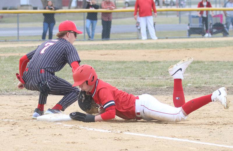 Streator's Colin Byers dives back to first base in time as Hall's Izzaq Zrust squeezes the throw on Tuesday, March 18, 2025 in Foley Field at Kirby Park in Spring Valley.