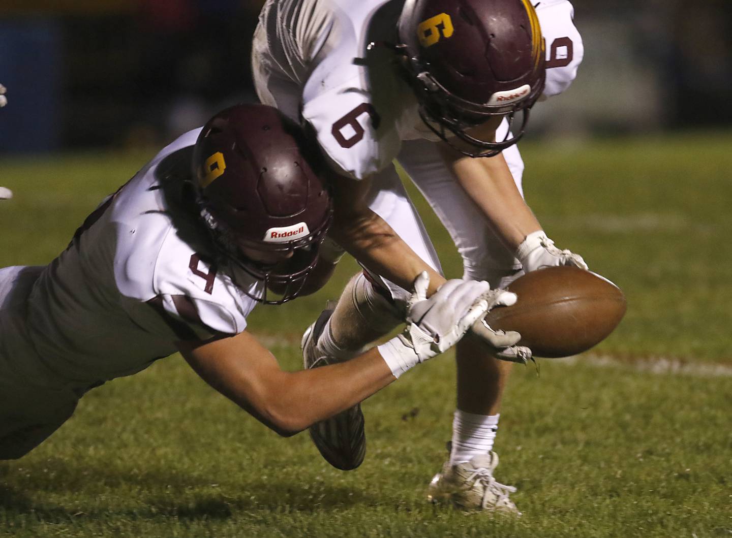 Richmond-Burton's Daniel Kalinowski and  Ryan Wisniewski recover a Johnsburg's Duke Mays fumble during a Kishwaukee River Conference football game on Friday, Oct.6, 2023, at Johnsburg High School.