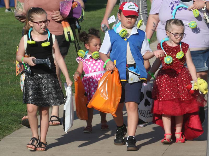 Kids dressed in Halloween theme costume enter for the Illinois Valley Pistol Shrimp Halloween in July on Wednesday, July 23, 2025 at Schweickert Stadium in Peru. The event featured a Trick or Treat Scavenger Hunt presented by Peru Federal Savings Bank, Pregame Performance from the Hocus Pocus Hags and a kids costume parade.