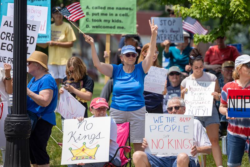 Protesters hold signs and wave flags at the “No Kings” protest on Saturday, June 14, 2025 at Rotary Park in Princeton.