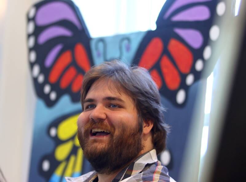 Thomas Egger, coordinator for the Creative Arts nonprofit organization, greets others during Monarchs and Music at Crystal Lake Main Beach Sunday.