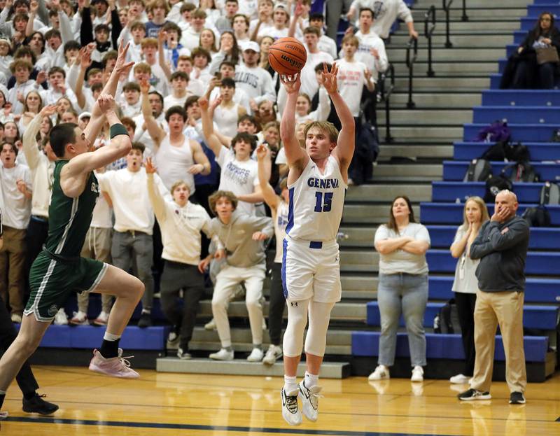 Glenbard West's Logan Brown (11) tries to stop a last second shot for three by Geneva's Jimmy Rasmussen (15) to win the game against against the Glenbard West in the IHSA Class 4A Geneva regional championship game Friday February 24, 2023 in Geneva.