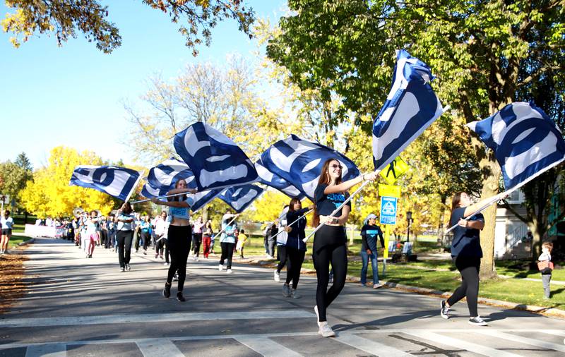 The Downers Grove South color guard performs  in the school’s annual homecoming parade on Friday, Oct. 20, 2023.