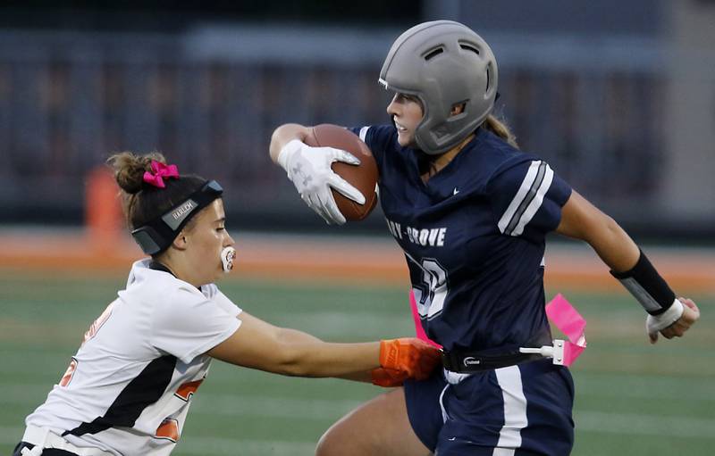 Cary-Grove's Brynlee Ahlquist tries to spin away from Harlem’s Ava Fitzsimmons during an IHSA McHenry Sectional semifinal girls flag football game on Monday, Oct. 13, 2025, at McCracken Field in McHenry.