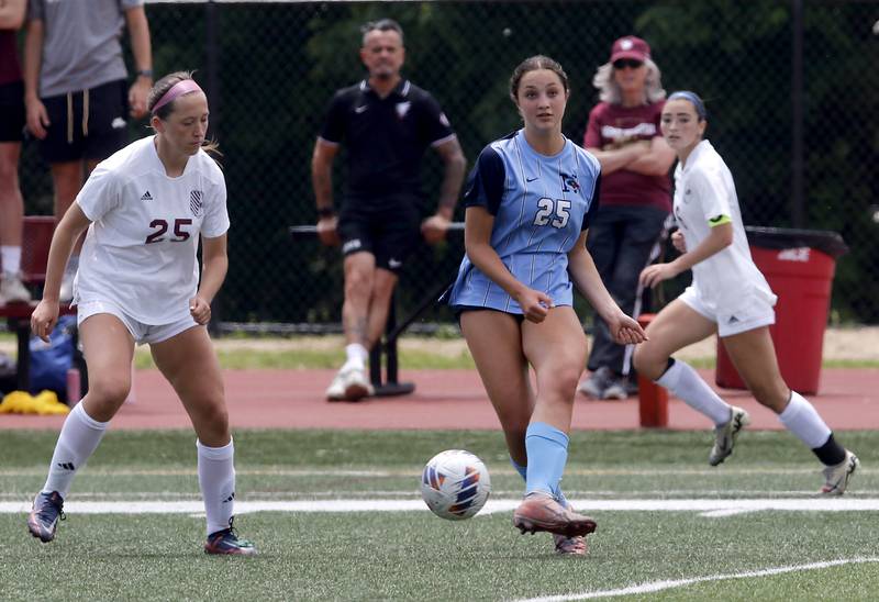 Nazareth Academy's Samantha Austin passes the ball as St. Ignatius College Prep's Maggie Helms Lakes'John Zutkis defends during a IHSA Class 2A State Girls Soccer semifinal match on Friday, June 6, 2025, at North Central College in Naperville.