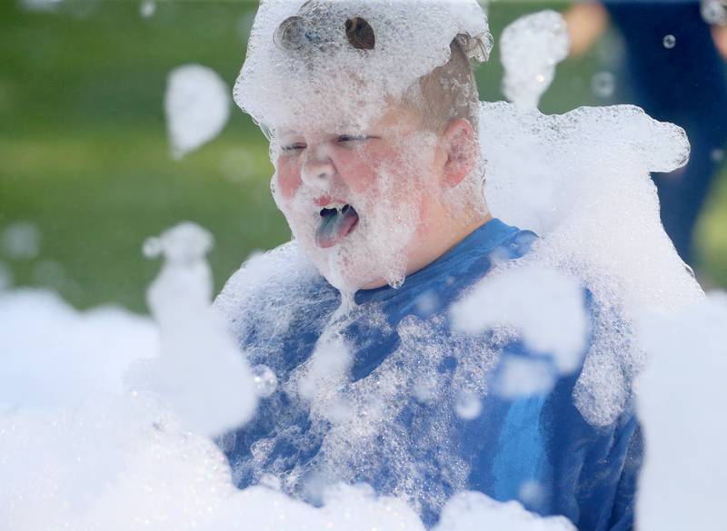 Bentley Bennett of La Salle, plays in a foam pit during the Spring Valley Lions Club 85th anniversary party on Friday, July 21, in the Lions Club shelter at Kirby Park in Spring Valley .