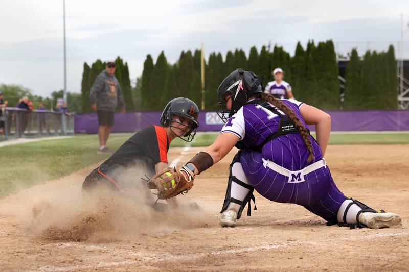 Beecher's Elena Kvasnicka beats the tag at home by Manteno's Ginny Kvasnicka during Beecher's 14-6 victory over Manteno in the Class 2A Manteno Regional championship on Friday, May 22, 2026.