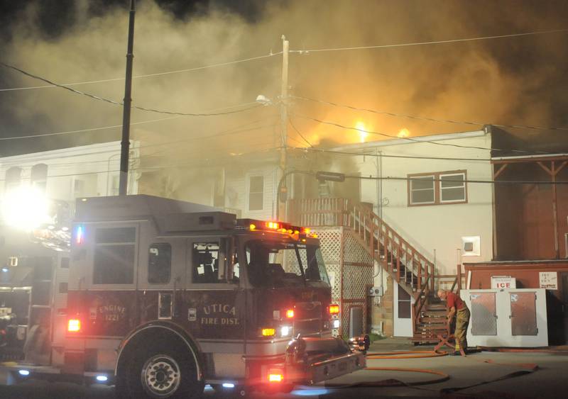 A Utica fire truck is one of the first to arrive to the scene of a fire above Skoogs Pub & Grill on Sunday, May 10, 2015 downtown Utica.