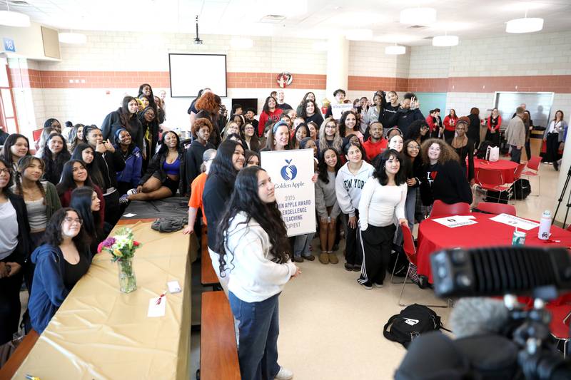 Bolingbrook High School teacher Erin Clifford is surrounded by many of her students after it was announced she had won a Golden Apple Award for Excellence in Teaching.