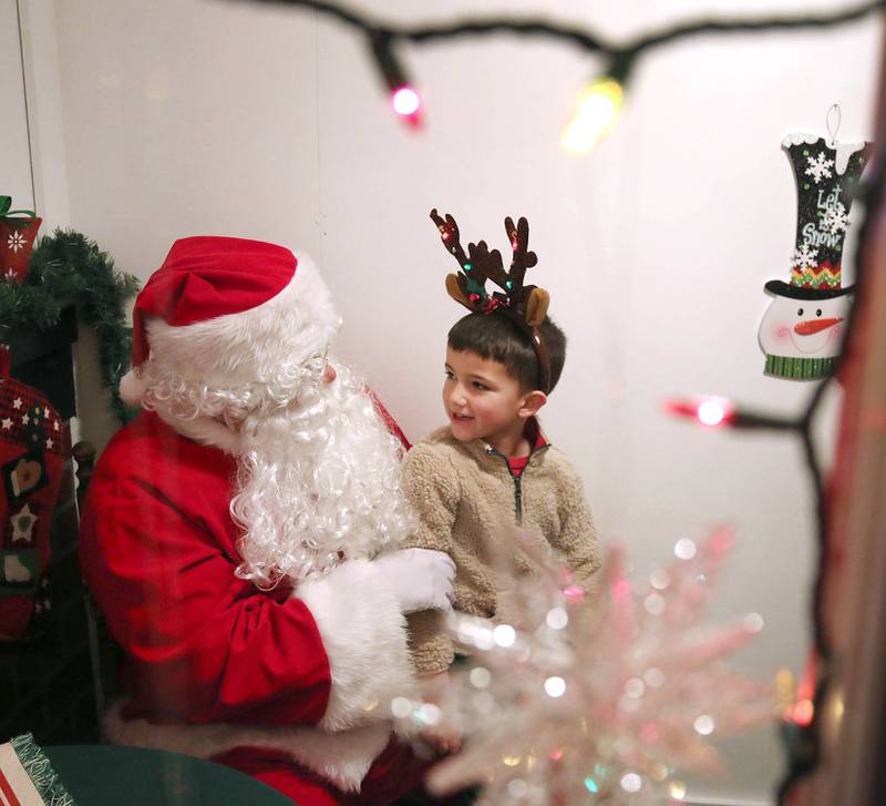 Kannen Cartee, 5, visits with Santa Friday, Dec. 2, 2022, during Celebrate the Season hosted by the Genoa Area Chamber of Commerce.