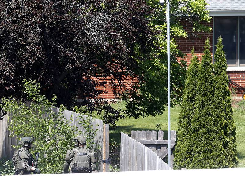 Law enforcement from area departments surround a home on Thursday, June 5, 2025, in the area of Venice Avenue and Court Street in McHenry.
