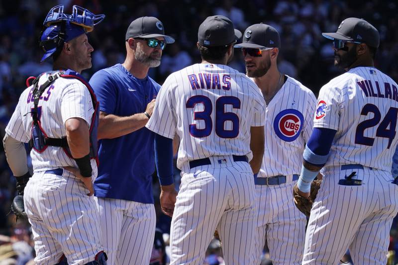 Chicago Cubs manager David Ross, second from left, and players wait for relief pitcher Adrian Sampson during the fifth inning of a baseball game against the Atlanta Braves in Chicago, Sunday, June 19, 2022.