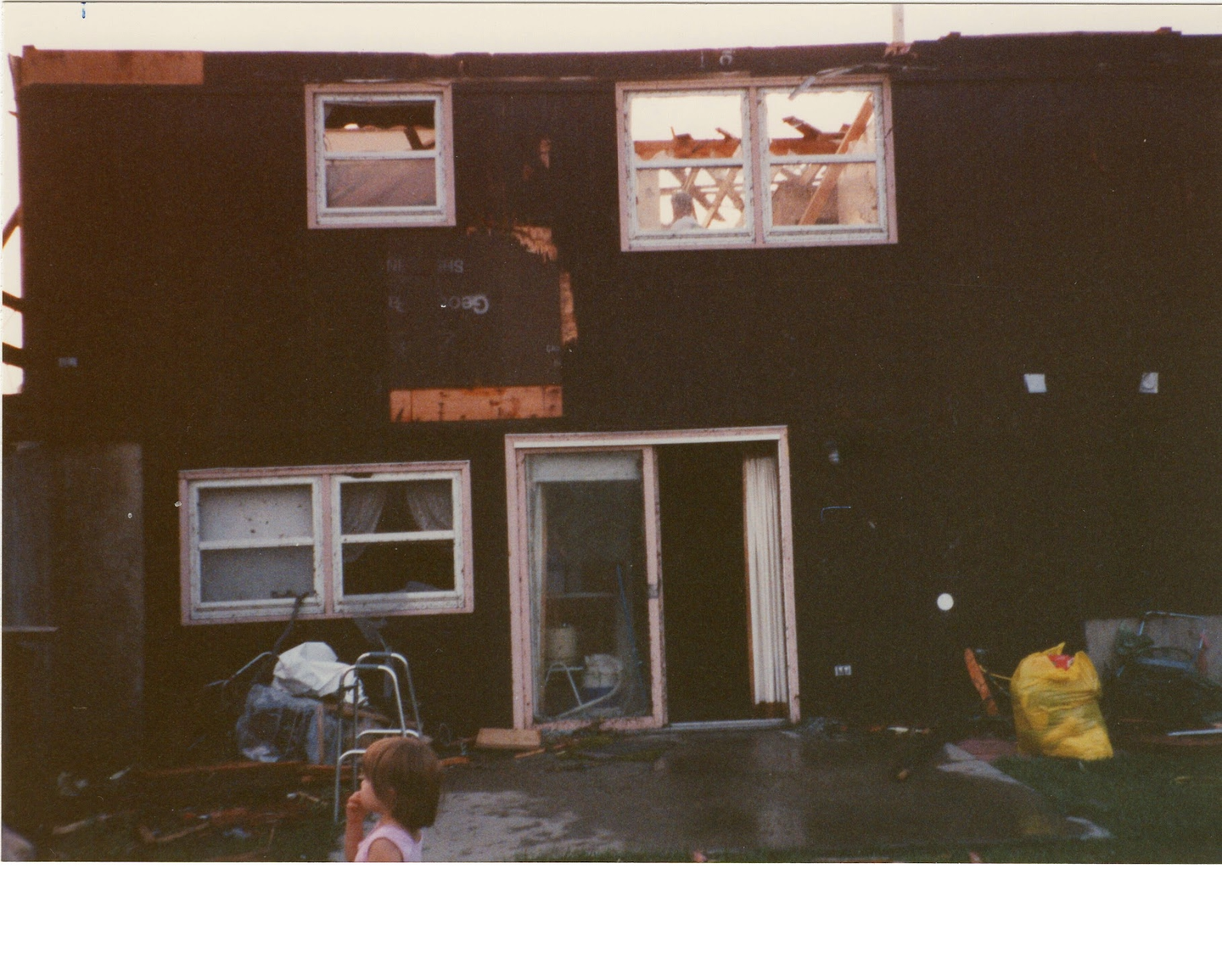 Jennifer Saari stands in back yard of her great-grandparents' Plainfield home in the aftermath of the August 28, 1990 tornado.
