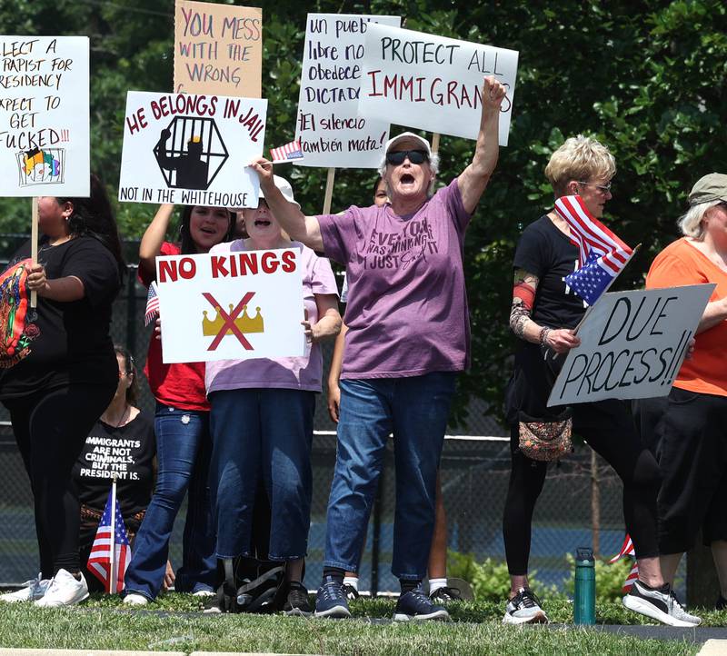 Waunita Rosenbaum, from Sycamore, yells slogans along Sycamore Road Saturday, June 14, 2025, during a No Kings rally at Hopkins Park in DeKalb. The group was protesting the policies of President Donald Trump and his administration.
