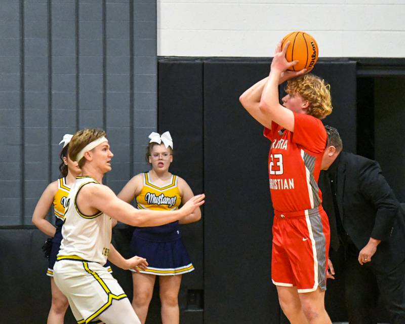 Aurora Christian's Asa Johnson, right,  takes a shot during the game on Friday Feb. 28, 2025, while being defended by Yorkville Christian's Brady Sovern (2) held at Indian Creek High School.