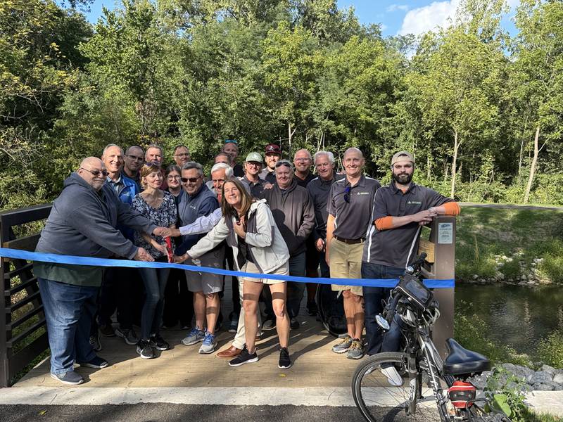 A crowd poses at a ribbon cutting for the Bridge at Belle Vue Park on Sept. 5, 2025, in Sugar Grove.