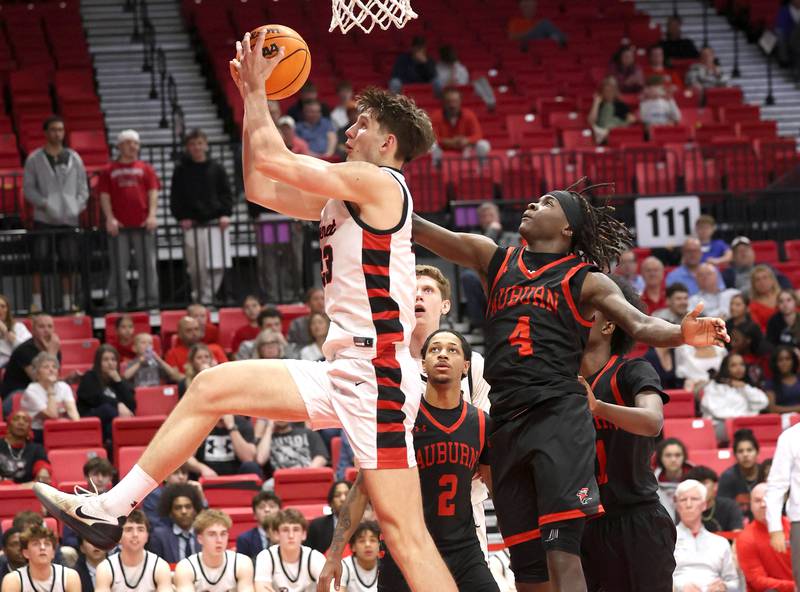 Benet’s Edvardas Stasys grabs a rebound in front of Auburn's NyAire Wright Monday, March 9, 2026, during their IHSA Class 4A supersectional matchup in the Convocation Center at Northern Illinois University in DeKalb.