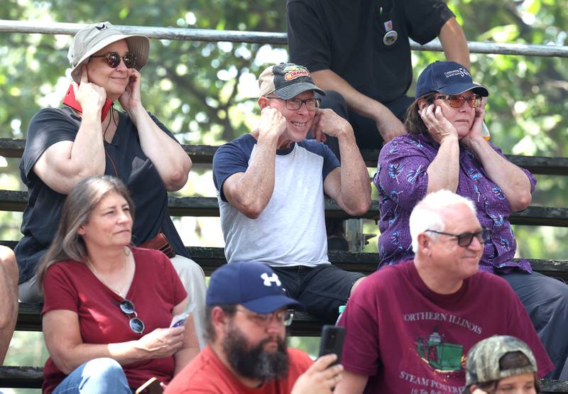 Spectators plug their ears as tractors blow their whistles Thursday, Aug. 8, 2024, during the 67th annual Sycamore Steam Show and Threshing Bee at Taylor Marshall Farm.