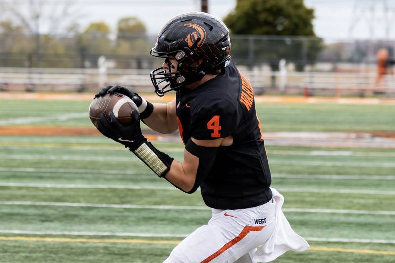 Lincoln-Way West's Ethan Swanson makes a catch before scoring a touchdown during a 7A varsity football playoff game against Kenwood at Lincoln-Way West on Nov. 8, 2025.