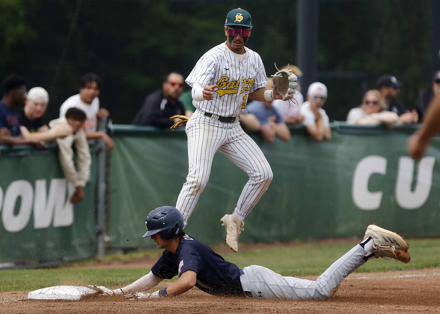 Cary-Grove's Ricky Barnes slides onto third base in front of Crystal Lake South's Yandel Ramirez during the IHSA Class 3A Grayslake Central Sectional Championship baseball game on Saturday, June 7, 2025, at Grayslake Central High School.