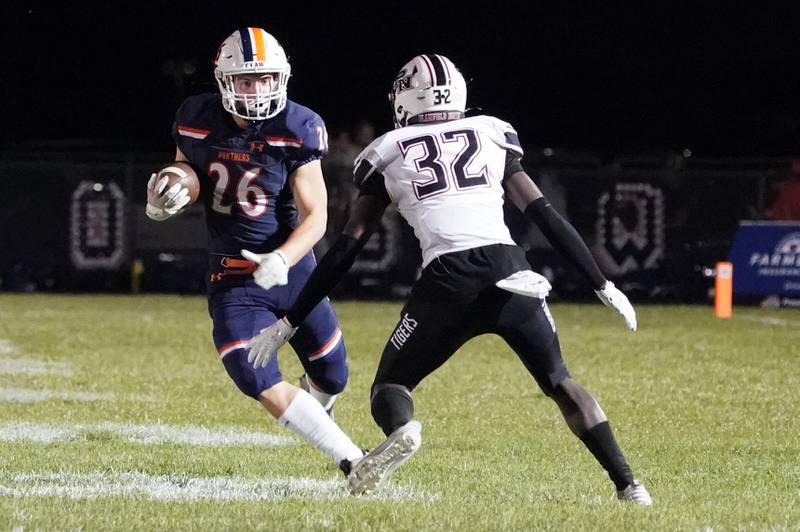 Oswego’s Dekker Zelensek (26) carries the ball against Plainfield North's Keith Cyracus (32) during a football game at Oswego High School on Friday, Sept. 27, 2024.