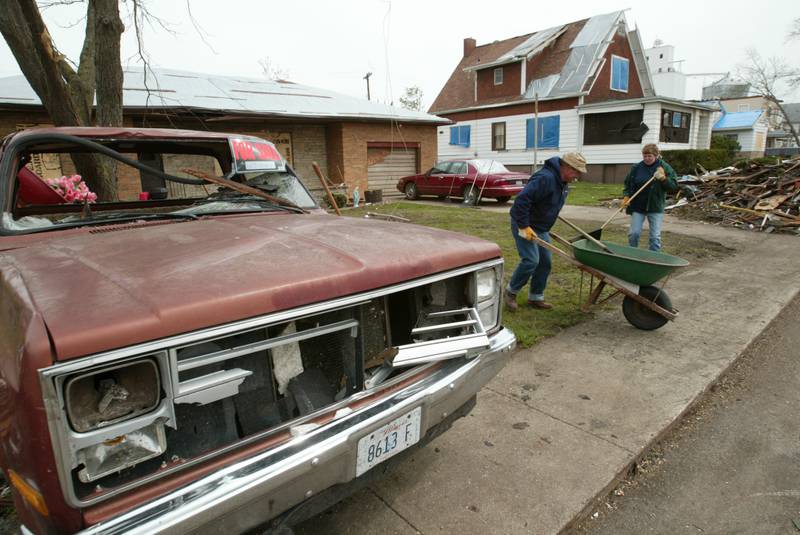 Utica residents clean up debris after the tornado on Wednesday, April 21, 2004.