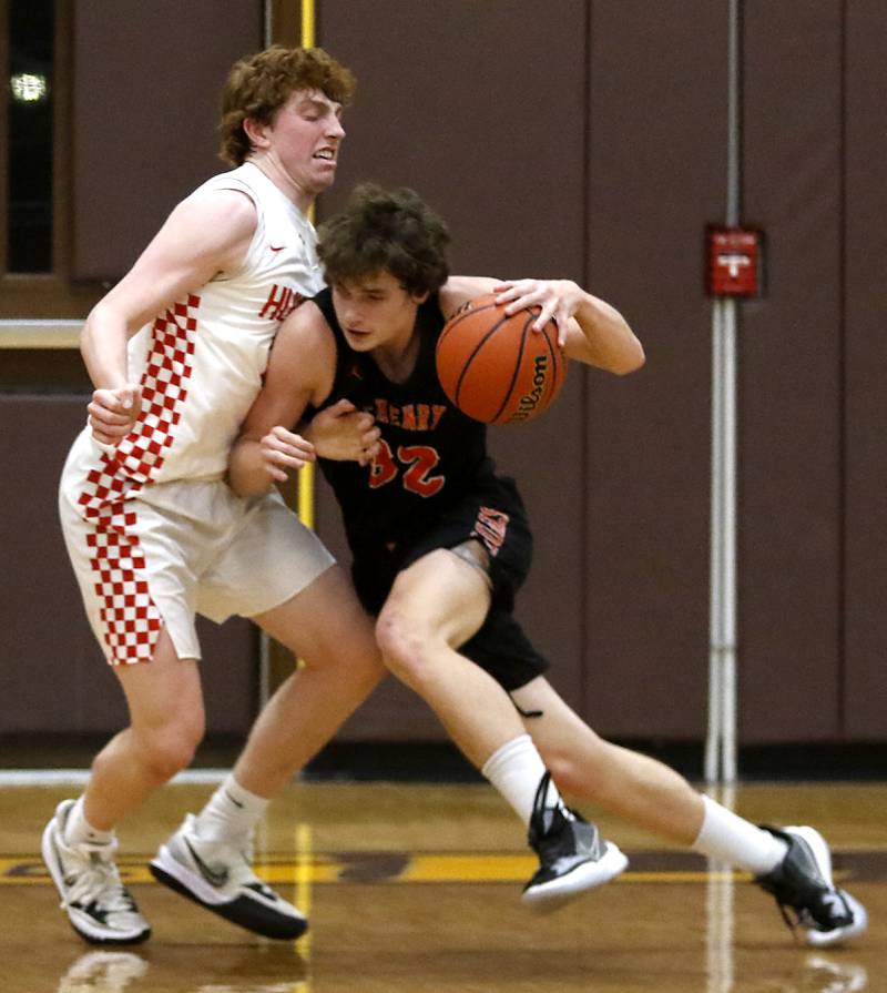 McHenry’s Anthony Fowler, right, tries to drive on Huntley's Adam Guazzo during a IHSA Class 4A Boys Regional basketball game Wednesday, Feb. 23, 2022, between Huntley and McHenry at Jacobs High School.
