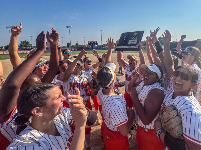 Oswego players raise the plaque in celebration after defeating Wheaton North to win the Class 4A Oswego Sectional Final at Oswego High School on Friday, June 6, 2025.