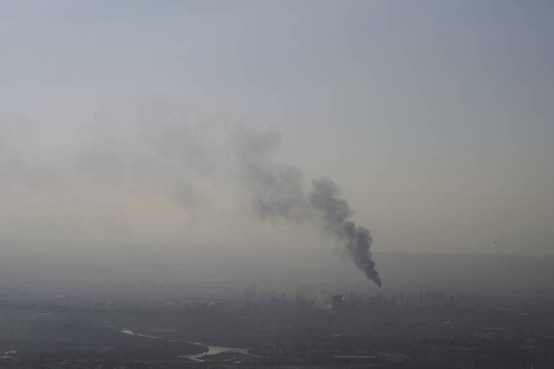 Smoke billows after an Iranian missile struck an oil refinery in Haifa, northern Israel, early Monday, June 16, 2025. (AP Photo/Ariel Schalit)