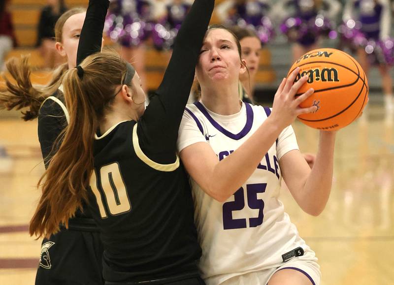 Rochelle's Jaydin Dickey goes to the basket against Sycamore's Cortni Kruizenga Friday, Dec. 5, 2025, during their game at Rochelle High School.