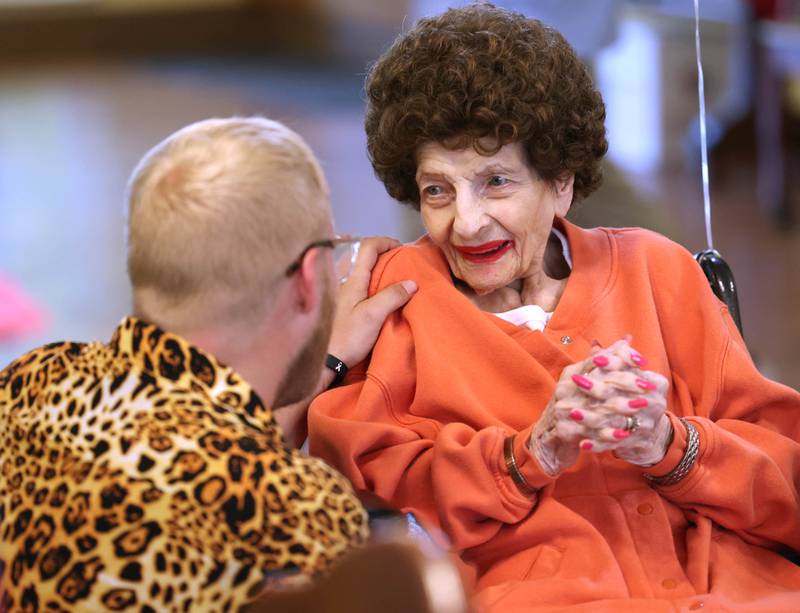 Claire Hubele, a resident at Heritage Woods of DeKalb, talks to Dean Wickstrom, resident services coordinator at the facility, Wednesday, July 9, 2025, during a party celebrating her 100th birthday.