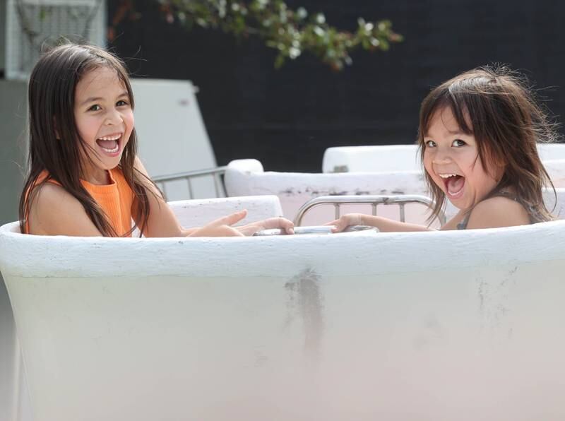 Evee Onate, (left) 5, and her sister Verity, 3, from DeKalb ride the teacups at the carnival during Corn Fest Friday, Aug. 25, 2023, in downtown DeKalb.