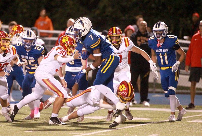 Wheaton North’s Matthew Shelton (center) carries the ball during a game against Batavia on Friday, Sept. 27, 2024 at Wheaton North.