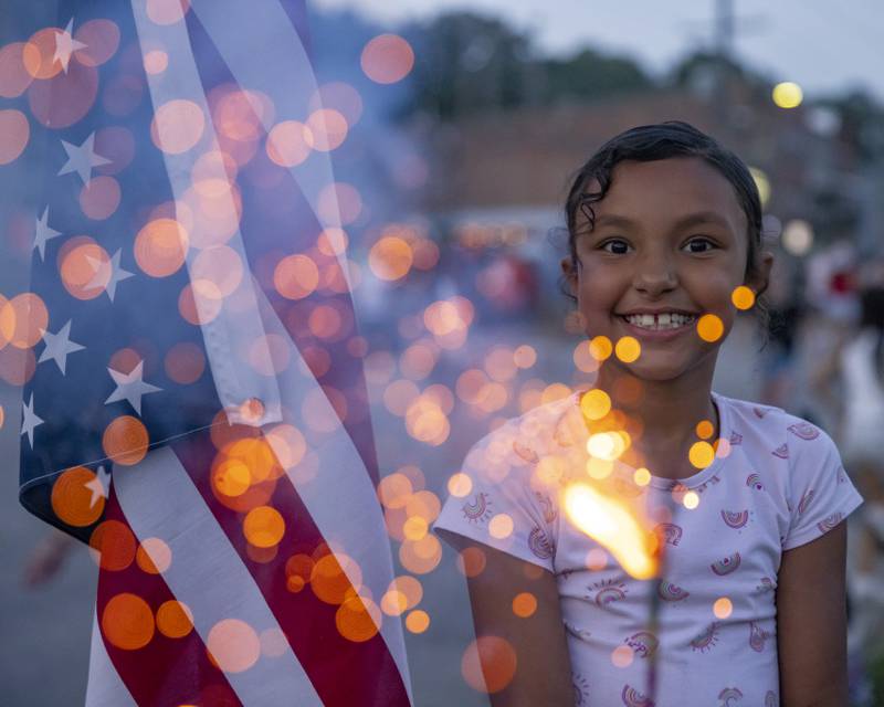 Arliohna Houston poses with her sparkler while waiting for the Peru fireworks to begin on Monday, July 3, 2023, on Water Street.