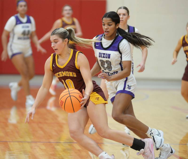 Richmond Burton's Daniella Mazzola (10)  dribbles as Dixon's Ahmyrie McGowan (23) defends at the Oregon Girls Basketball Tip-Off Tournament on Wednesday, Nov. 20, 2024 at the Blackhawk Center in Oregon.
