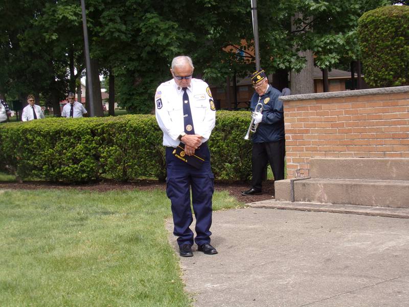 Heads are bowed as the benediction is read Monday, May 27, 2024, during the Memorial Day ceremony at Veterans Memorial Plaza in Streator's City Park.