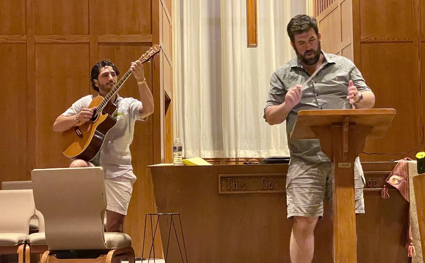 Fox Valley Opera music director J. MacArthur Willaert (right) conducts while tenor Vincent McPherson plays the guitar during rehearsal at the Oswego Presbyterian Church on June 3, 2025.