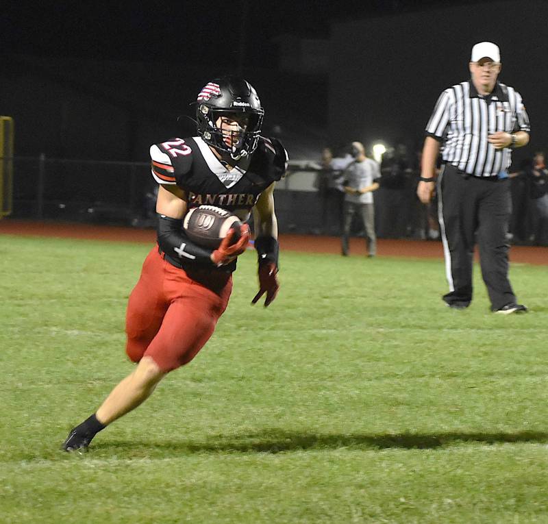 Erie-Prophetstown's Tristan Hovey (22) runs with the ball against Sterling Newman on Friday, Sept. 13, 2024. The Panthers fell to the Comets 41-13. suffering their first loss of the season.