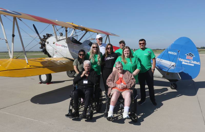 Princeton Veterans Ed Manahan and LeeAnn Joyce, pose with Liberty Village Staff and pilot Darryl Fisher next to a 1942 Boeing Stearman A-75 Primary Trainer during a Veteran Dream Flight on Tuesday, Sept 2, 2025 at the Illinois Valley Regional Airport in Peru.