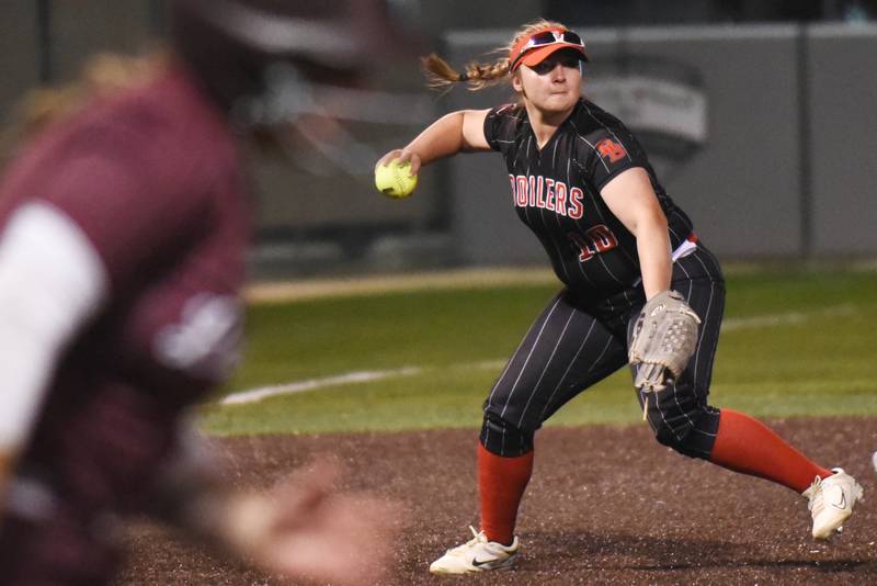 Bradley-Bourbonnais' Rhaina Boggess, right, attempts to throw Lockport's Sydney Amschler out at first base during the Class 4A Illinois Wesleyan Supersectional Monday, June 9, 2025.